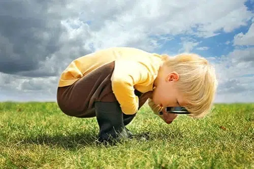 Toddler using magnifying glass at early learning centre