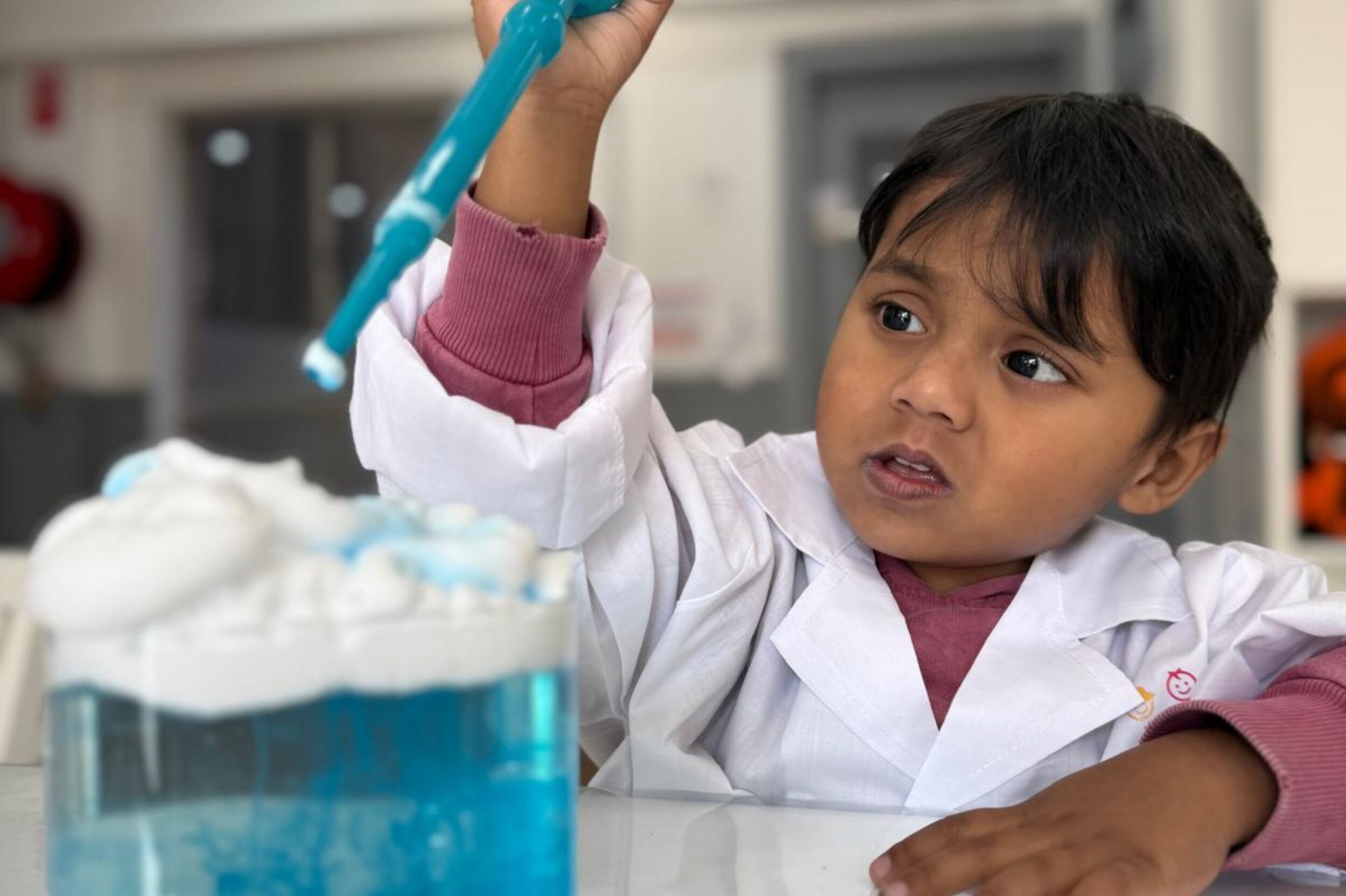 Young child engaging in a hands-on STEM science experiment at Little Scribblers early learning centre.
